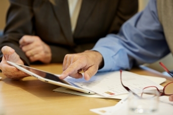 Financial Advisor showing client information on a tablet